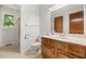 Bathroom with wood vanity, cream walls, a standard toilet, and a window view at 4964 Stafford Mill Rd, Liberty, NC 27298