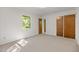 Bright bedroom with neutral carpet, closet and bright window overlooking the yard at 4964 Stafford Mill Rd, Liberty, NC 27298