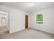 Bedroom with neutral carpet, white walls, a window view and wood closet door at 4964 Stafford Mill Rd, Liberty, NC 27298