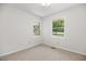 Bedroom with neutral carpet, white walls, and two windows with a view of the yard at 4964 Stafford Mill Rd, Liberty, NC 27298