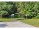 Metal carport in a lush green yard with a concrete pad at 4964 Stafford Mill Rd, Liberty, NC 27298