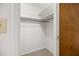 A bright closet features neutral carpet, white walls, shelf and a hanging rod at 4964 Stafford Mill Rd, Liberty, NC 27298