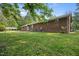View of the back of the home from the lawn with a detached carport at 4964 Stafford Mill Rd, Liberty, NC 27298