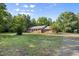 Charming brick home with well-manicured lawn, complemented by mature trees in a serene setting at 4964 Stafford Mill Rd, Liberty, NC 27298