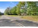 Charming brick home nestled among mature trees, offering a peaceful setting and inviting curb appeal at 4964 Stafford Mill Rd, Liberty, NC 27298