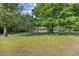 Charming one-story home with mature trees, covered porch, and a spacious green lawn at 4964 Stafford Mill Rd, Liberty, NC 27298