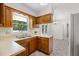 This kitchen features a double sink below a window, wood cabinets, and a breakfast nook at 4964 Stafford Mill Rd, Liberty, NC 27298