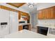 Bright kitchen has wooden cabinets, black appliances and white countertops at 4964 Stafford Mill Rd, Liberty, NC 27298