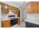 Kitchen features black appliances and wooden cabinets at 4964 Stafford Mill Rd, Liberty, NC 27298