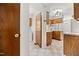 View of the kitchen featuring wooden cabinets, laminate countertops, and access to the laundry room at 4964 Stafford Mill Rd, Liberty, NC 27298