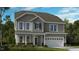 Charming two-story home featuring gray siding, a two-car garage, and a well-maintained front lawn at 527 Claftin St, Sanford, NC 27330