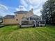 Spacious backyard with a two-story home that includes a nice deck and screened-in porch for outdoor relaxation at 5301 Peacenest Dr, Raleigh, NC 27610