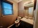 Bathroom with a large window and a sink with a granite countertop at 5301 Peacenest Dr, Raleigh, NC 27610