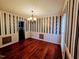 Formal dining room with hardwood floors, modern chandelier, and elegant wallpaper at 5301 Peacenest Dr, Raleigh, NC 27610