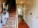 Accessible hallway with stair lift and hardwood flooring at 5301 Peacenest Dr, Raleigh, NC 27610