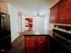 Well-lit kitchen with dark countertops, wooden cabinetry, and modern appliances at 5301 Peacenest Dr, Raleigh, NC 27610