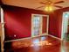 Bright living area with hardwood floors, access to patio, and red accent wall at 5301 Peacenest Dr, Raleigh, NC 27610
