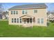 Well maintained backyard and patio of tan colored two story home with lawn at 800 Tree Green Ln, Wake Forest, NC 27587