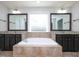 Luxurious bathroom featuring a soaking tub, granite countertops, and dark wood cabinets at 800 Tree Green Ln, Wake Forest, NC 27587