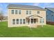 A lush backyard enhances this home's back exterior, featuring a cozy, covered patio for outdoor relaxation and entertainment at 800 Tree Green Ln, Wake Forest, NC 27587