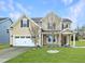 Charming two-story home with a well-manicured lawn and a two-car garage at 800 Tree Green Ln, Wake Forest, NC 27587