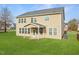 Rear exterior view of the home showing the covered patio and large windows overlooking the spacious backyard at 800 Tree Green Ln, Wake Forest, NC 27587