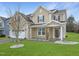 Charming two-story home with a well-manicured lawn and a two-car garage at 800 Tree Green Ln, Wake Forest, NC 27587