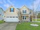 Charming two-story home with a well-manicured lawn and a two-car garage at 800 Tree Green Ln, Wake Forest, NC 27587