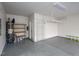 A well-lit garage featuring built-in storage, a water heater, and epoxy flooring, combining functionality with a clean aesthetic at 800 Tree Green Ln, Wake Forest, NC 27587