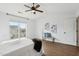 Bright bedroom featuring a ceiling fan, hardwood floors, and white walls at 8204 Yaxley Hall Dr, Raleigh, NC 27616