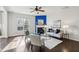 Sunlit living room features a fireplace and hardwood flooring at 8204 Yaxley Hall Dr, Raleigh, NC 27616