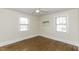 Bright bedroom featuring hardwood floors and two large windows at 931 Eastern Ave, Nashville, NC 27856