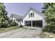 Exterior shot showcasing the home's architecture, including a partially open garage and well-maintained landscaping at 931 Eastern Ave, Nashville, NC 27856