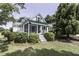Charming exterior featuring mature landscaping, a screened porch, and a well-maintained lawn at 931 Eastern Ave, Nashville, NC 27856