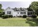 Charming two-story home with green lawn, bushes, and white picket fence at 931 Eastern Ave, Nashville, NC 27856
