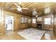 Cozy living room with wood paneling, fireplace, and hardwood floors at 931 Eastern Ave, Nashville, NC 27856