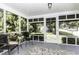 Relaxing screened porch with comfortable seating and an outdoor rug provides the perfect spot to enjoy the fresh air at 931 Eastern Ave, Nashville, NC 27856