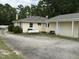 Rear view of home featuring parking area, home, and propane tank at 9439 Clayton Blvd, Clayton, NC 27520