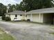 View of the home's backyard, featuring a storage tank and convenient parking area at 9439 Clayton Blvd, Clayton, NC 27520