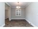 Dining room area with hardwood floors, neutral paint, and elegant light fixture at 9439 Clayton Blvd, Clayton, NC 27520