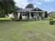 Charming yellow home with a welcoming front porch and beautifully landscaped front yard at 9439 Clayton Blvd, Clayton, NC 27520