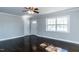 Living room with dark hardwood floors, a ceiling fan, natural light, and an exterior door at 9439 Clayton Blvd, Clayton, NC 27520