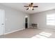 Bedroom with neutral colored carpet, ceiling fan, and bright window views at 9439 Clayton Blvd, Clayton, NC 27520