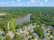 Aerial view showcasing homes near a scenic lake and lush greenery at 1 Lake Hill Dr, Durham, NC 27713