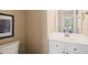Half bath with a white vanity, framed mirror, and view into the dining area at 1 Lake Hill Dr, Durham, NC 27713