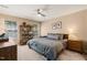 Bedroom with neutral walls, ceiling fan, and a display shelving unit at 1 Lake Hill Dr, Durham, NC 27713