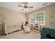 Neutral Bedroom featuring a wooden crib, comfortable seating, and ample natural light at 1 Lake Hill Dr, Durham, NC 27713