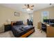 Bedroom with a ceiling fan, neutral walls, and a built-in desk area at 1 Lake Hill Dr, Durham, NC 27713