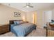 Bedroom with neutral walls, ceiling fan, and an ensuite bathroom at 1 Lake Hill Dr, Durham, NC 27713