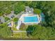 Aerial view of a community pool area with a large pool, lounge chairs, and recreational amenities at 1 Lake Hill Dr, Durham, NC 27713